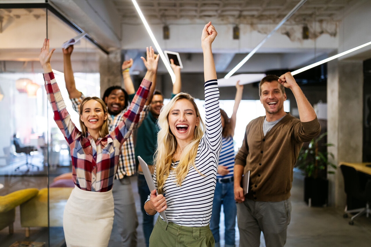 Excited professionals collaborating in a modern office – Career opportunities at Ripple Broadband